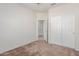 Bedroom featuring carpet, neutral walls, a closet with sliding doors, and an ensuite bathroom at 25945 W Runion Dr, Buckeye, AZ 85396
