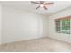Bright, blank canvas bedroom featuring tile flooring, a window with natural light, and a ceiling fan, ready for personal touch at 25945 W Runion Dr, Buckeye, AZ 85396