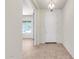 Welcoming entryway with tile flooring, an open doorway to another room, and a modern light fixture creating a stylish entrance at 25945 W Runion Dr, Buckeye, AZ 85396
