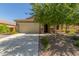 Attractive home featuring a two-car garage, desert landscaping, and a well-maintained lawn, enhancing its curb appeal at 25945 W Runion Dr, Buckeye, AZ 85396