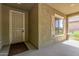 Inviting front porch with a security door, a window with decorative shutters, and stone-accented columns adding charm at 25945 W Runion Dr, Buckeye, AZ 85396