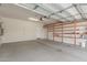 Spacious garage with concrete floor, shelving, and access door at 25945 W Runion Dr, Buckeye, AZ 85396
