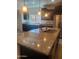 Bright kitchen featuring granite counters, stainless steel appliances, and dark wood cabinets at 25945 W Runion Dr, Buckeye, AZ 85396