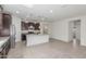 Bright, open kitchen with granite countertops, a large island, stainless steel appliances, and ample cabinet space at 25945 W Runion Dr, Buckeye, AZ 85396
