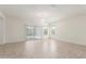 Bright living room featuring tile floors, neutral walls, and a sliding glass door at 25945 W Runion Dr, Buckeye, AZ 85396
