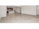 Open-concept living space with tile flooring, a view into the kitchen, and plenty of natural light creating an airy feel at 25945 W Runion Dr, Buckeye, AZ 85396