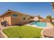 Pool in a well-manicured backyard, featuring artificial turf, a basketball hoop, and mature trees at 2680 E Daniel Dr, Gilbert, AZ 85298