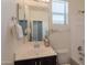 Well-lit bathroom features a modern vanity with dark cabinets, a silver faucet, and a large mirror at 2680 E Daniel Dr, Gilbert, AZ 85298