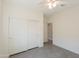 Bright bedroom features tile flooring, a ceiling fan, and a closet with sliding doors at 2680 E Daniel Dr, Gilbert, AZ 85298