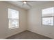Well-lit bedroom with tile flooring, two windows offering natural light, and neutral walls, creating a serene atmosphere at 2680 E Daniel Dr, Gilbert, AZ 85298