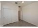 Bright bedroom features tile flooring, a ceiling fan, and a closet with sliding doors at 2680 E Daniel Dr, Gilbert, AZ 85298