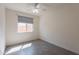 Bedroom with neutral walls, gray tile flooring, and a window with roller shades at 2680 E Daniel Dr, Gilbert, AZ 85298
