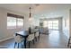 Open floor plan featuring a dining area with modern table and chairs, adjacent to the living room and pool view at 2680 E Daniel Dr, Gilbert, AZ 85298