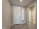 Bright entryway featuring neutral walls, tile flooring, a white front door, and seamless transition to the rest of the home at 2680 E Daniel Dr, Gilbert, AZ 85298