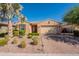 Inviting single-story home featuring a well-manicured front yard with desert landscaping and a charming covered entryway at 2680 E Daniel Dr, Gilbert, AZ 85298