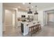 Bright kitchen features white cabinets, granite countertops, stainless steel appliances, and an island with seating at 2680 E Daniel Dr, Gilbert, AZ 85298
