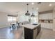 Open-concept kitchen with a view to a dining area and living space, featuring a large island and stainless appliances at 2680 E Daniel Dr, Gilbert, AZ 85298