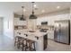 Modern kitchen featuring a large center island with seating, granite countertops, pendant lighting, and stainless appliances at 2680 E Daniel Dr, Gilbert, AZ 85298