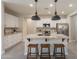 Bright kitchen featuring white cabinetry, granite countertops, stainless steel appliances and island with seating at 2680 E Daniel Dr, Gilbert, AZ 85298
