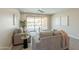 Comfortable living room featuring neutral furnishings, tile flooring, a ceiling fan, and a calming view to the backyard pool at 2680 E Daniel Dr, Gilbert, AZ 85298