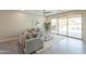 Bright living room boasts neutral decor, tile flooring, a ceiling fan, and seamless access to the backyard pool at 2680 E Daniel Dr, Gilbert, AZ 85298