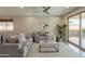 Spacious living room featuring modern furnishings, tile floors, recessed lighting, and seamless backyard views at 2680 E Daniel Dr, Gilbert, AZ 85298