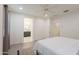Bright bedroom featuring an open doorway, tiled floors, and a ceiling fan at 2680 E Daniel Dr, Gilbert, AZ 85298