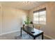 Office space with large window, chandelier, and a dark wood desk over a neutral rug at 2680 E Daniel Dr, Gilbert, AZ 85298