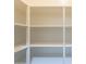 White shelving provides plenty of storage space in this walk-in pantry at 2680 E Daniel Dr, Gilbert, AZ 85298