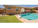 Backyard pool with a basketball hoop, situated near a well-maintained lawn and the home's exterior at 2680 E Daniel Dr, Gilbert, AZ 85298