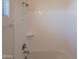 Clean bathroom shower featuring a white tub, shower head, and built in storage, enhancing the bathing experience at 2680 E Daniel Dr, Gilbert, AZ 85298