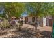 Charming backyard featuring covered patio, lush greenery, and seating area, perfect for outdoor enjoyment at 2896 W Hayden Peak Dr, San Tan Valley, AZ 85144