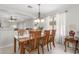 Dining area featuring neutral paint, tile flooring, a chandelier, and a window with white curtains at 2896 W Hayden Peak Dr, San Tan Valley, AZ 85144