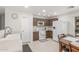 Efficient kitchen with wooden cabinets, modern white appliances and breakfast table at 2896 W Hayden Peak Dr, San Tan Valley, AZ 85144