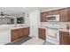Functional kitchen with white countertops, wooden cabinets, and modern appliances at 2896 W Hayden Peak Dr, San Tan Valley, AZ 85144