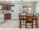 Bright kitchen area with white appliances and wood dining table by the sliding glass doors at 2896 W Hayden Peak Dr, San Tan Valley, AZ 85144