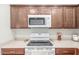 Close up of bright kitchen area with white countertops, wooden cabinets, and modern appliances at 2896 W Hayden Peak Dr, San Tan Valley, AZ 85144