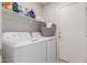 Functional laundry room equipped with washer, dryer, and ample storage shelving at 2896 W Hayden Peak Dr, San Tan Valley, AZ 85144