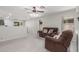 Comfortable living room showcasing a plush sofa, ceiling fan, and neutral decor at 2896 W Hayden Peak Dr, San Tan Valley, AZ 85144
