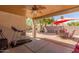 Covered patio with ceiling fan, outdoor seating, and desert landscaping at 2896 W Hayden Peak Dr, San Tan Valley, AZ 85144