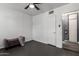 Bedroom featuring gray tile floors, a ceiling fan, and a cozy upholstered bench at 2941 N 19Th Ave # 95, Phoenix, AZ 85015