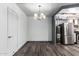 Open dining room featuring modern light fixture and wood-look flooring at 2941 N 19Th Ave # 95, Phoenix, AZ 85015
