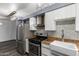 Modern kitchen featuring stainless steel appliances, wood countertops, and a stylish mosaic tile backsplash at 2941 N 19Th Ave # 95, Phoenix, AZ 85015