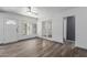 Well-lit living room featuring a large window, ceiling fan, and wood-look floors at 2941 N 19Th Ave # 95, Phoenix, AZ 85015