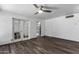 Bright living room with french doors, ceiling fan, and wood-look floors at 2941 N 19Th Ave # 95, Phoenix, AZ 85015