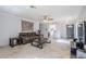 Spacious living room features tiled flooring, ceiling fan and adjacent kitchen and entry way at 3351 W Via Del Sol Dr, Phoenix, AZ 85027