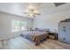 Bright bedroom featuring wood floors, ceiling fan, and a Winchester safe at 3351 W Via Del Sol Dr, Phoenix, AZ 85027