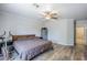 Bedroom with neutral walls, ceiling fan, wood floors, and an exercise bike at 3351 W Via Del Sol Dr, Phoenix, AZ 85027