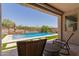 Patio seating area overlooking a pool and landscaped backyard on a sunny day at 34009 N 29Th Dr, Phoenix, AZ 85085