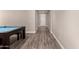 Spacious game room featuring a pool table with hardwood-style flooring and neutral-toned walls at 34009 N 29Th Dr, Phoenix, AZ 85085